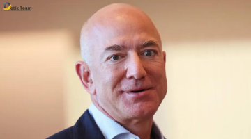 Blurred image of an individual in a suit, possibly representing Jeff Bezos, against a plain background with ‘Etik Team’ text visible.