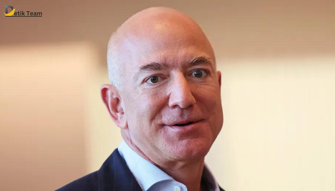 Blurred image of an individual in a suit, possibly representing Jeff Bezos, against a plain background with ‘Etik Team’ text visible.